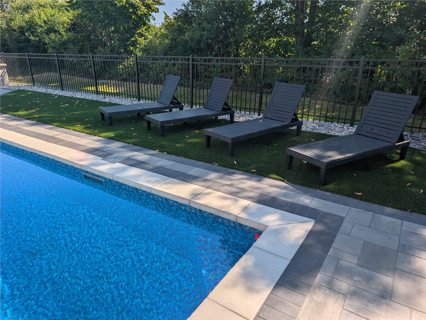 Finished pool, coping, pavers, and lounge area