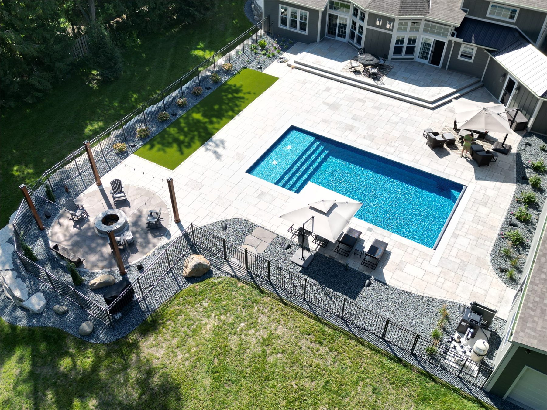 Aerial view of a finished Einstein pool and complete backyard