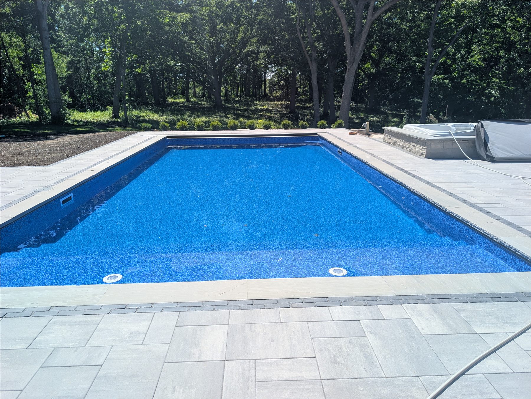 Finished Einstein pool in a wooded backyard
